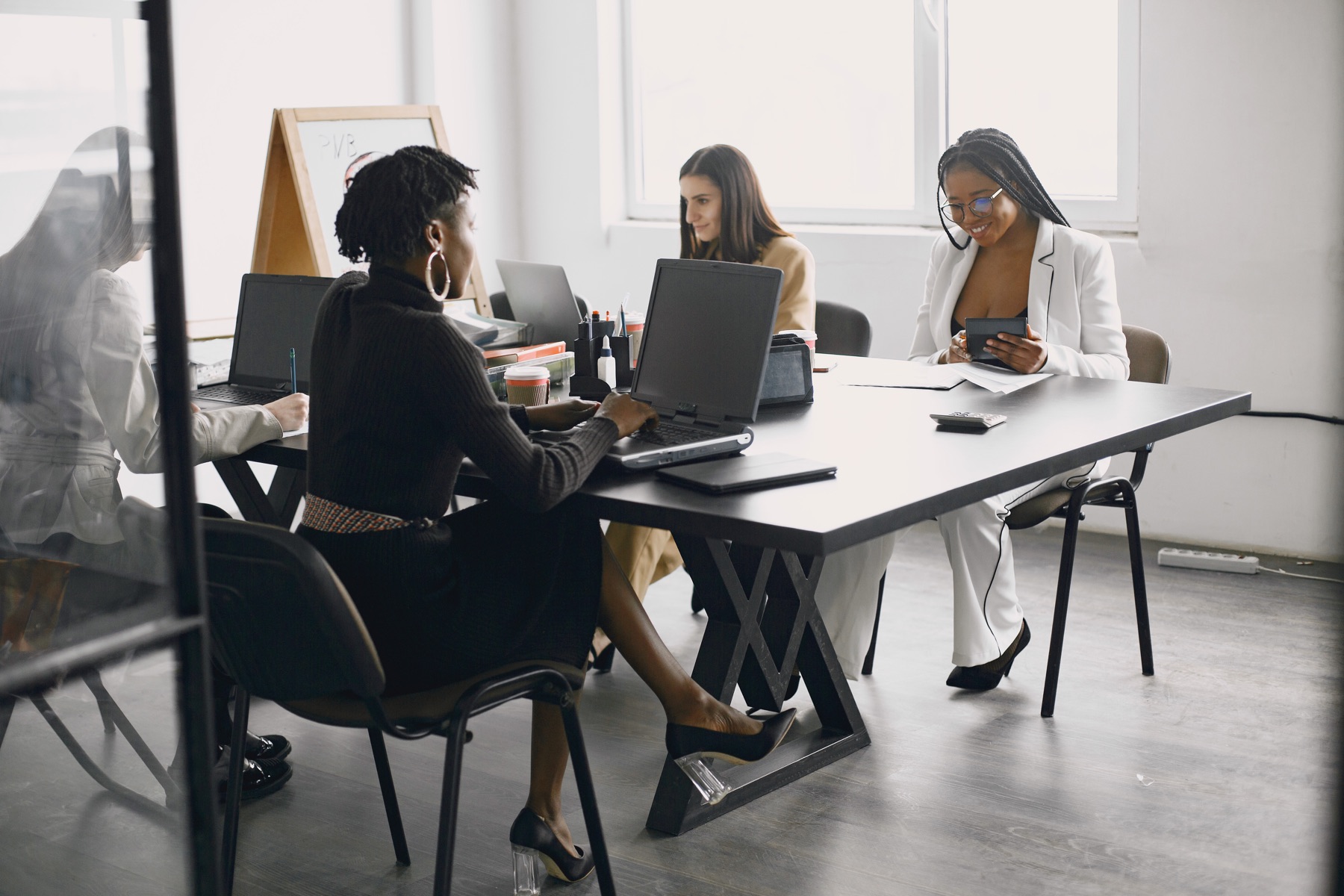 Businesswomen reviewing compliance documentation